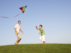 images/young-parent-father-with-child-playing-in-a-field.jpg